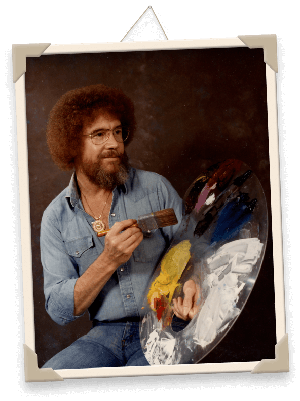 Ein gerahmtes Bild von Bob Ross mit Palette und Pinsel.